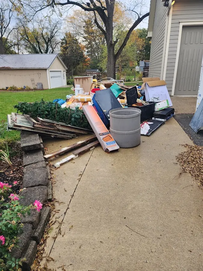 Dumpster being loaded with debris for Residential Dumpster Rental in Foster